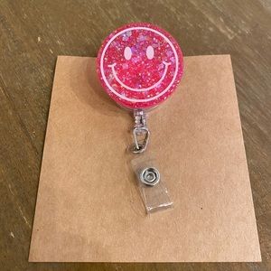 Smiley face badge reel